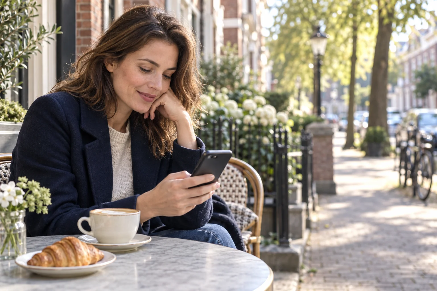 Illustrative customer enjoying a coffee while checking her phone